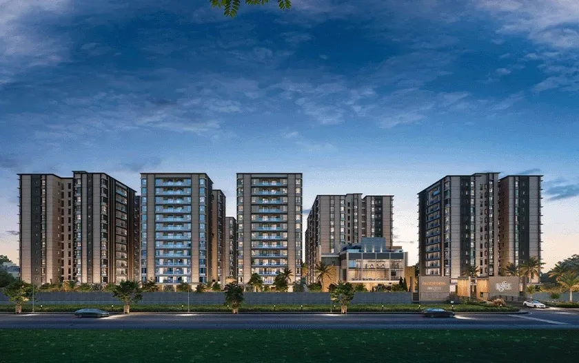 Inspire towers and club seen from the road at dusk