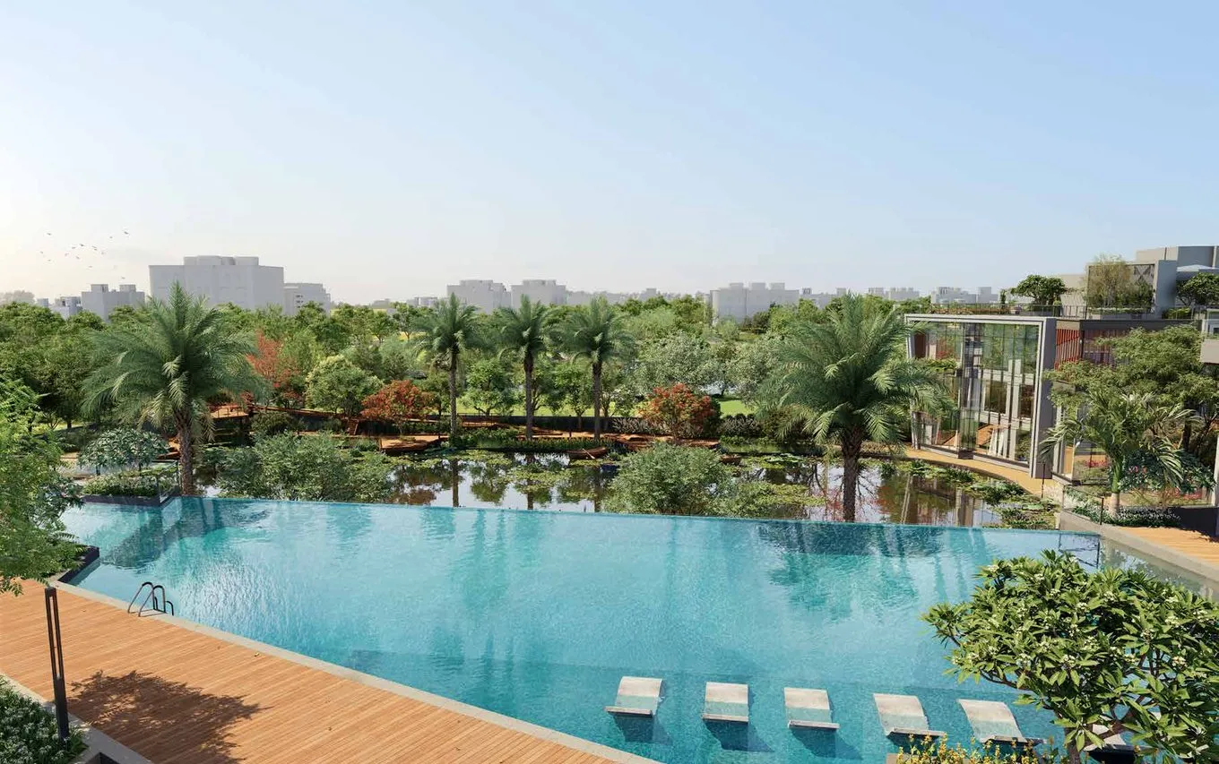 Infinity-edge swimming pool with wet loungers facing the pond