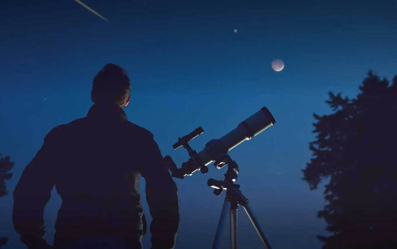 Star gazing with a telescope at night
