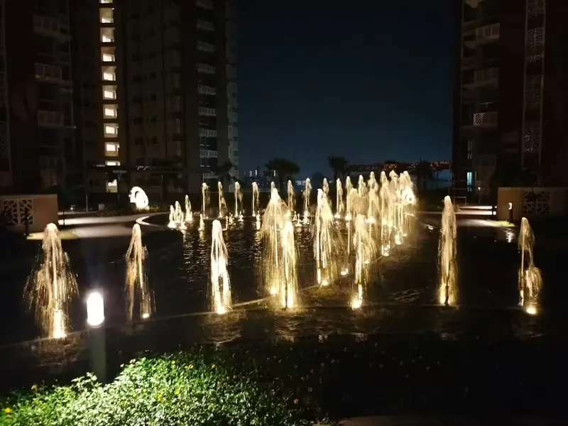 Interactive fountains on the podium at night